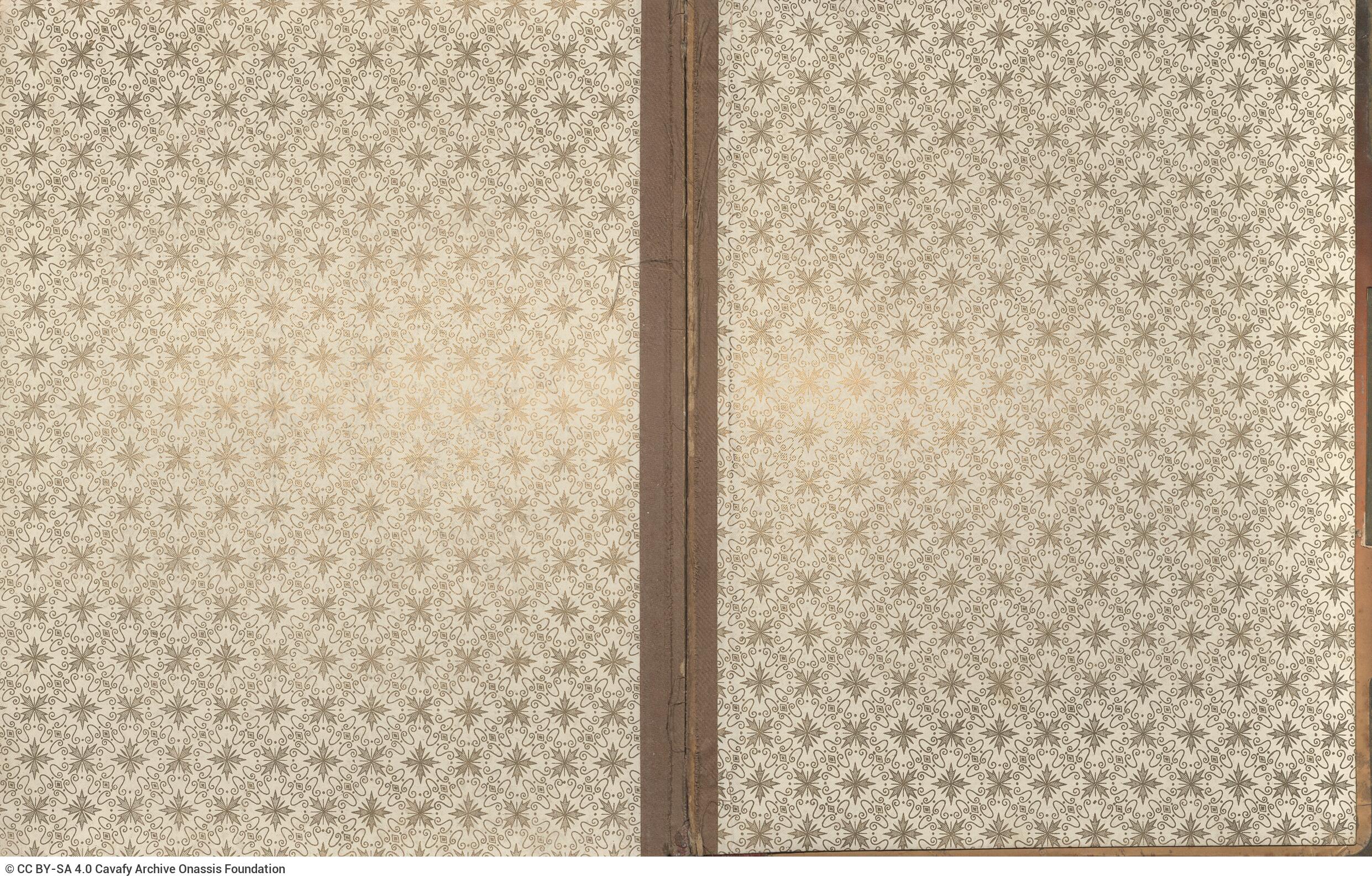 Photo album made of leather with details of metallic flowers and metallic lock. The photo frames are empty.