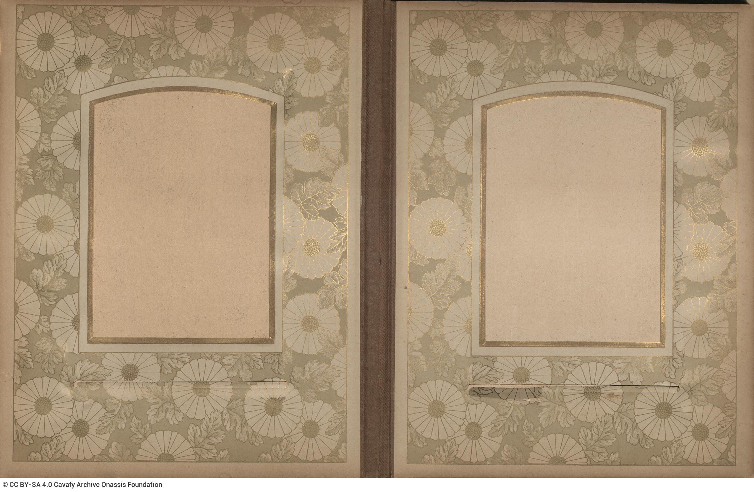 Photo album made of leather with details of metallic flowers and metallic lock. The photo frames are empty.