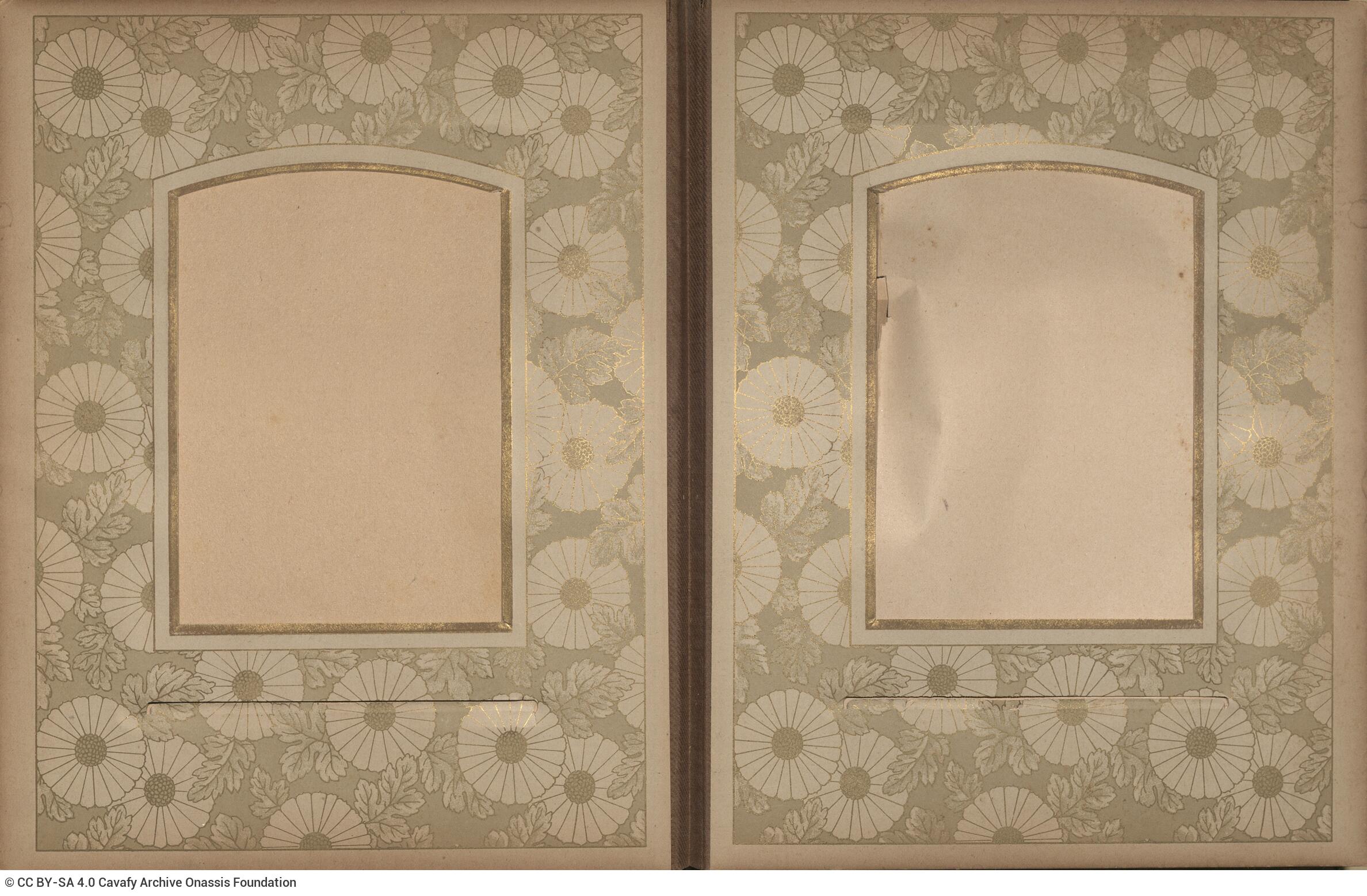 Photo album made of leather with details of metallic flowers and metallic lock. The photo frames are empty.