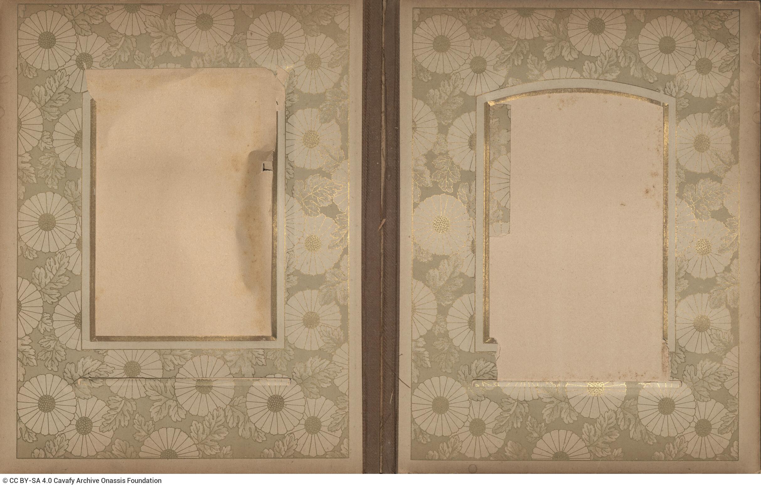 Photo album made of leather with details of metallic flowers and metallic lock. The photo frames are empty.