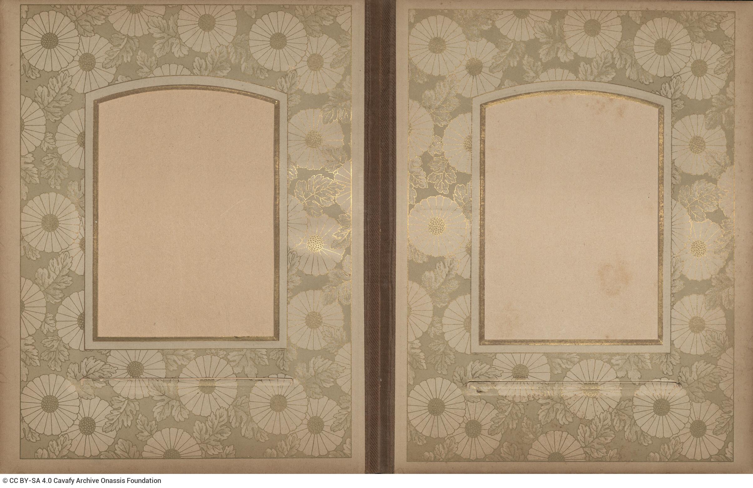 Photo album made of leather with details of metallic flowers and metallic lock. The photo frames are empty.