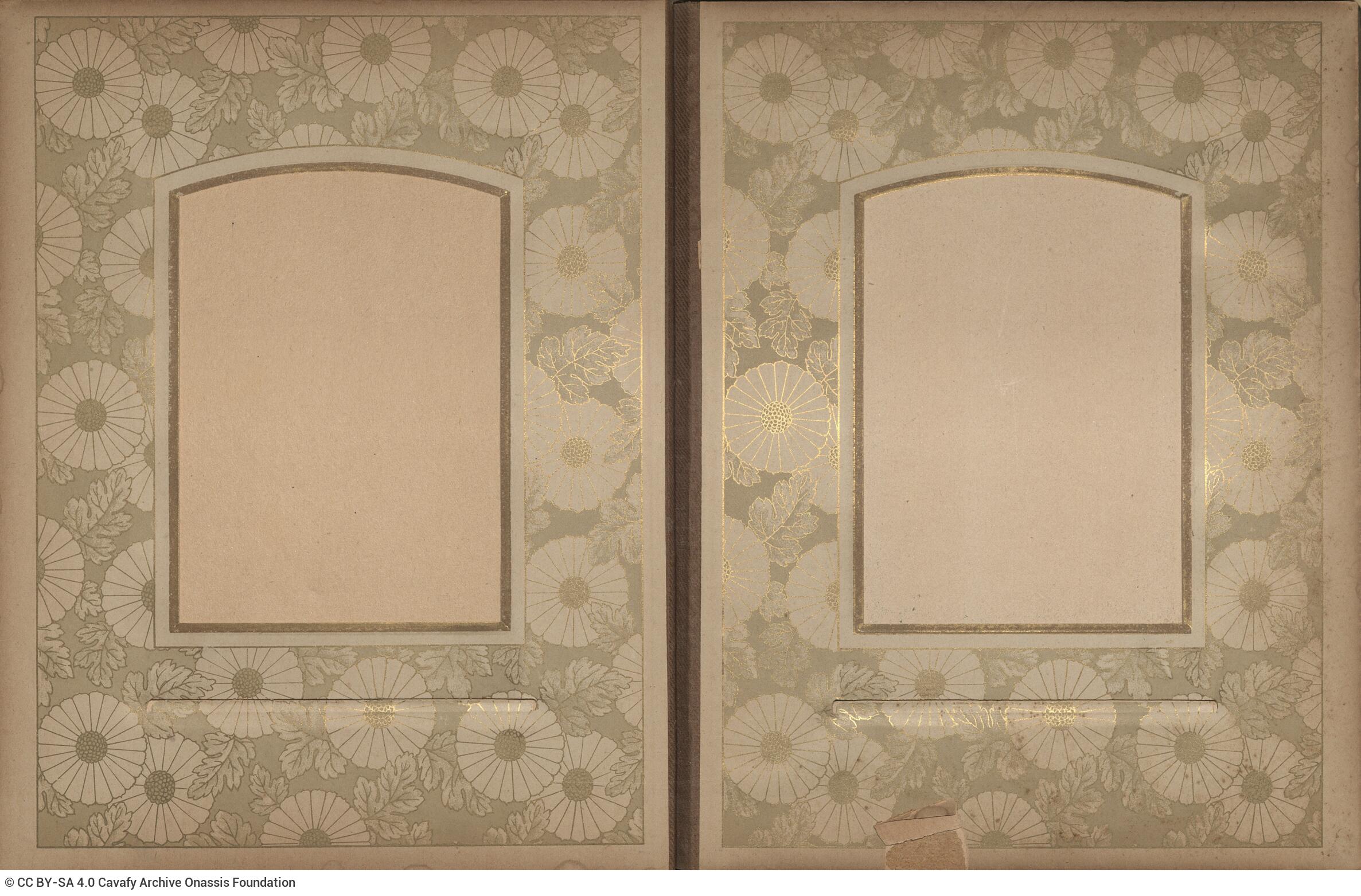 Photo album made of leather with details of metallic flowers and metallic lock. The photo frames are empty.