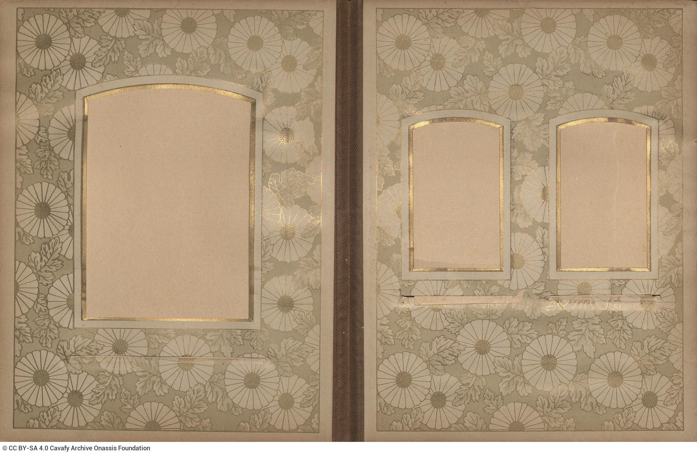 Photo album made of leather with details of metallic flowers and metallic lock. The photo frames are empty.