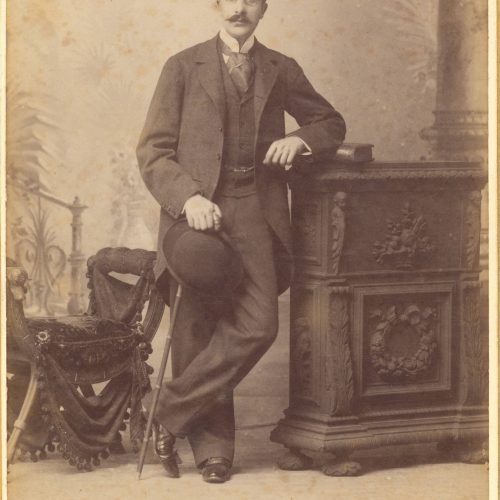 Undated photographic portrait of Cavafy by the photo shop of Fettel & Bernard in Alexandria. The poet has a mustache, he wear