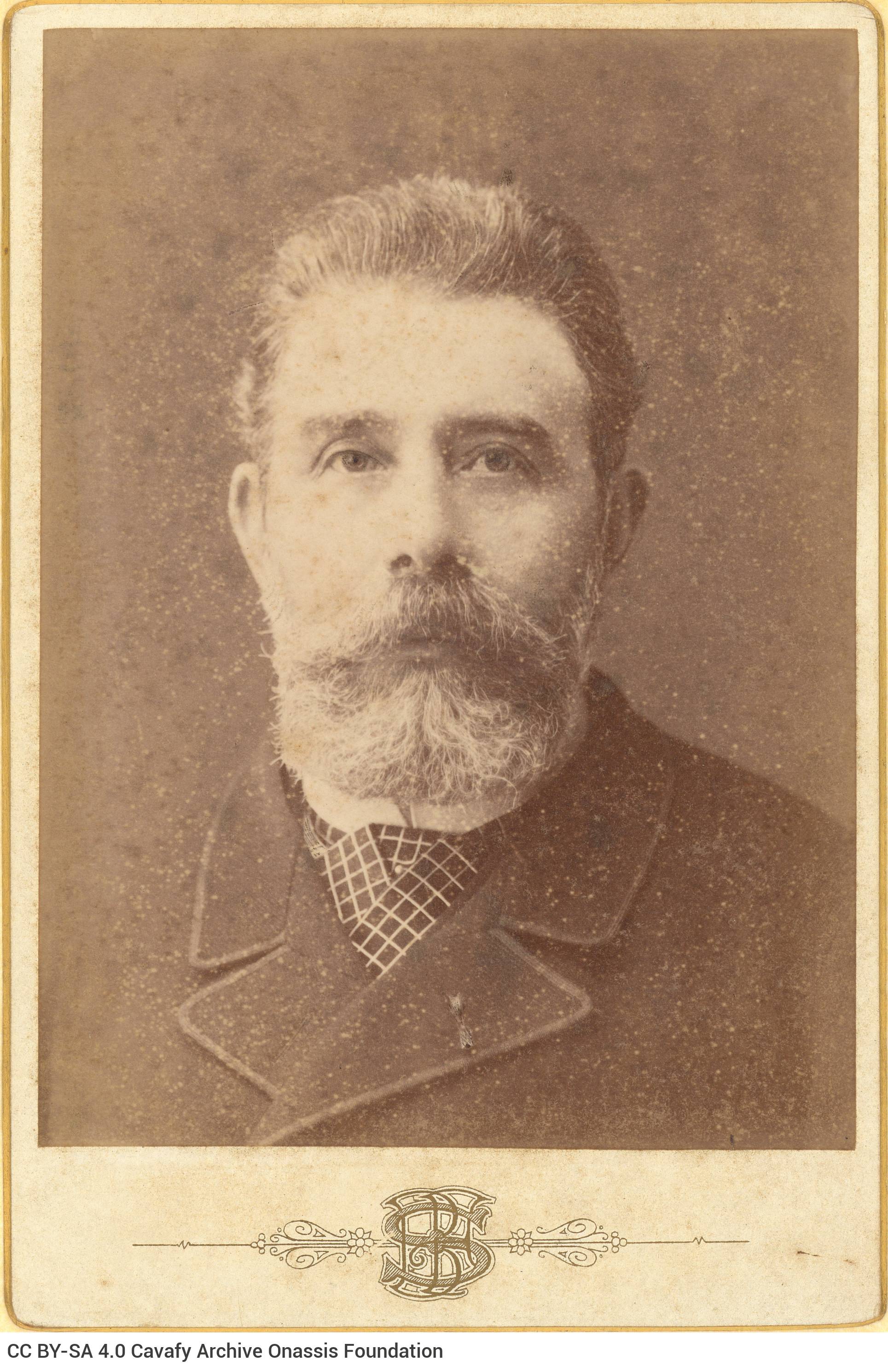 Photographic portrait of a man in a moustache, beard and plaid necktie. The logo of the photo shop in the lower part of the r