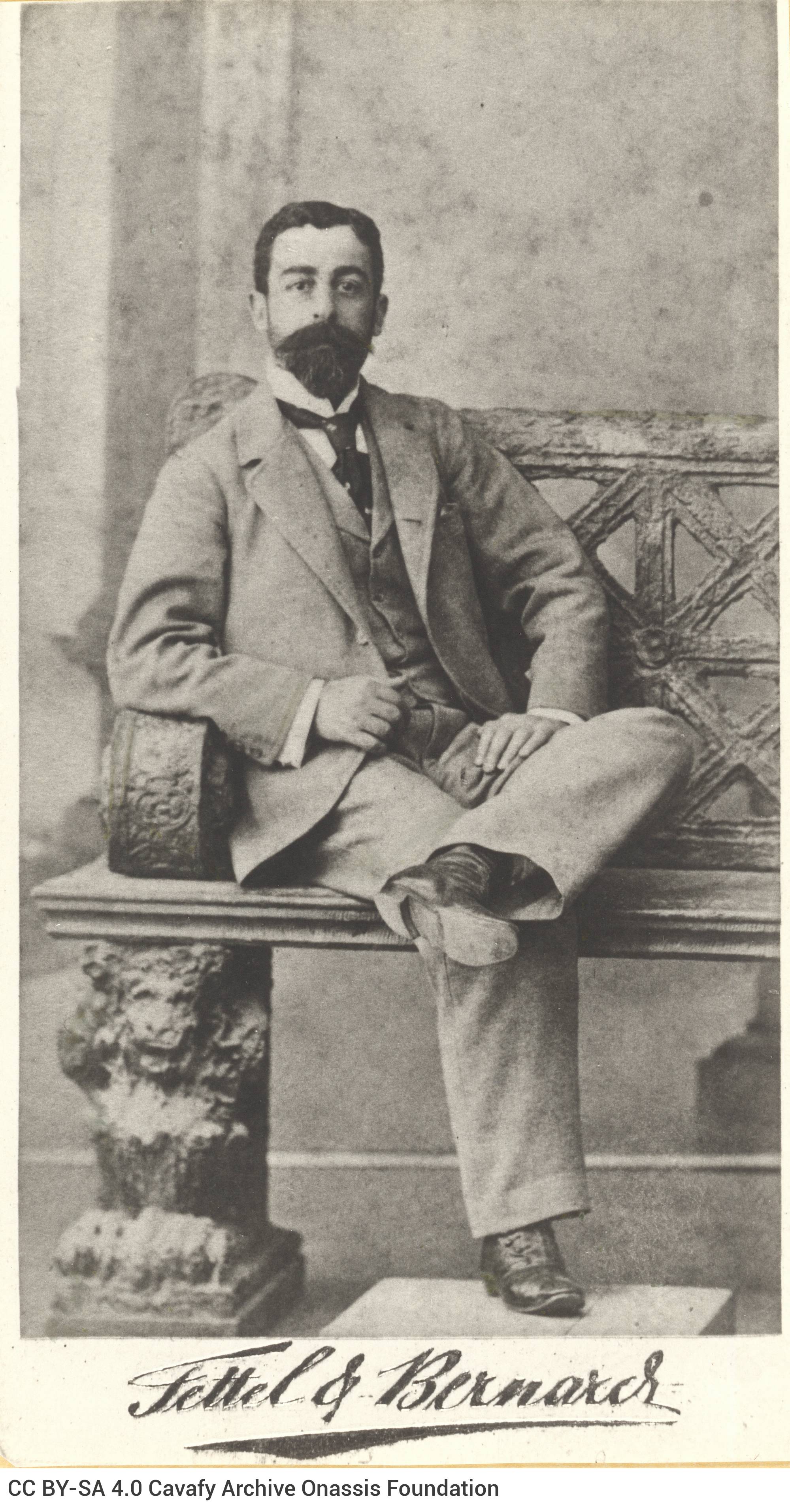 Photograph of Paul Cavafy seated, with a moustache and a beard. The logo of the photo shop in the lower part of the recto as 