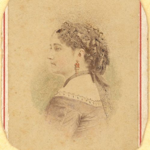 Hand-coloured photograph of Charikleia Cavafy at a young age. She is depicted in profile view, wearing her hair in an artful 