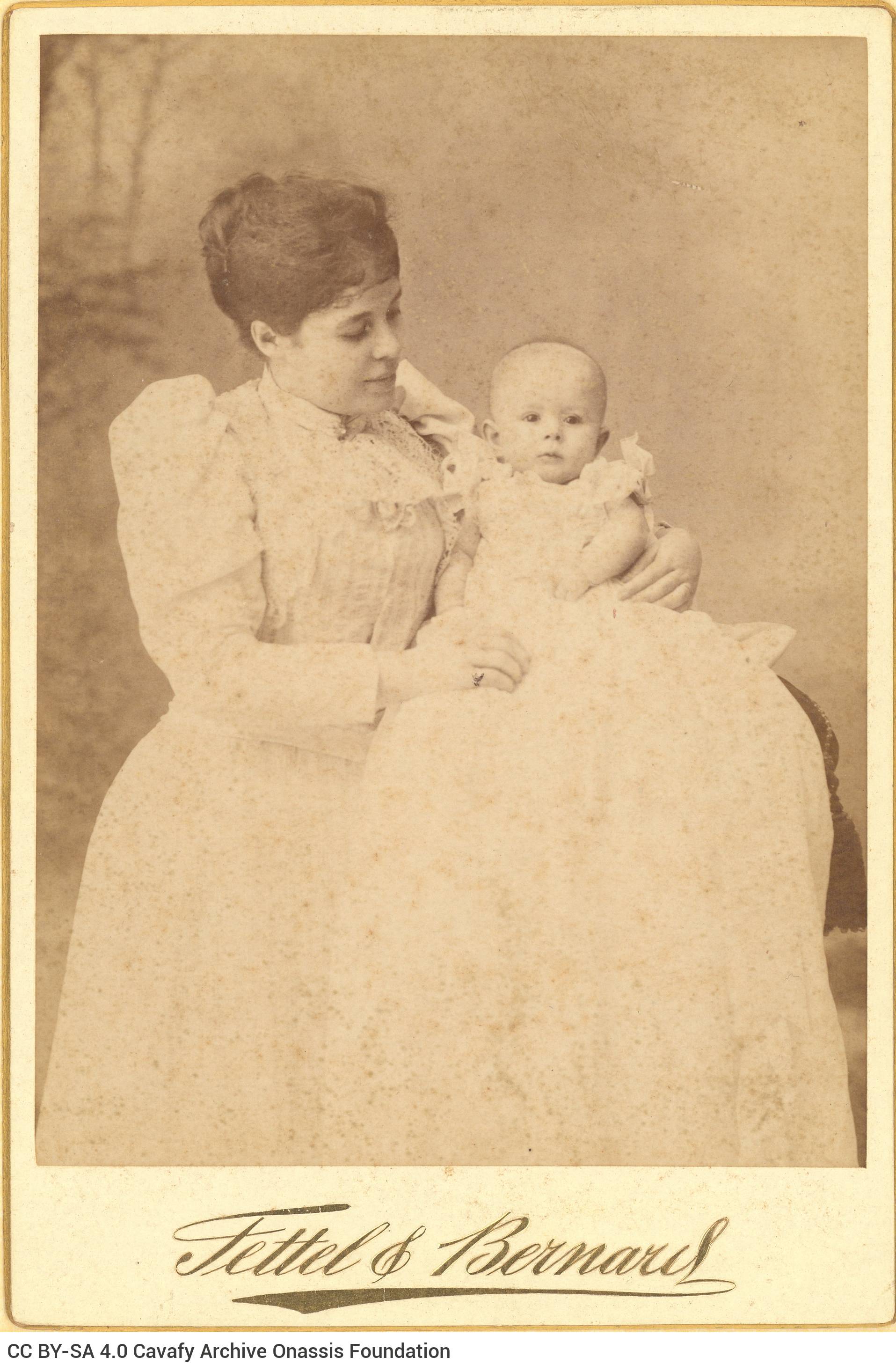 Photograph of Maria (Marie) Cavafy, wife of Aristeidis Cavafy, née Vourou, with their daughter Charikleia in her arms. It is