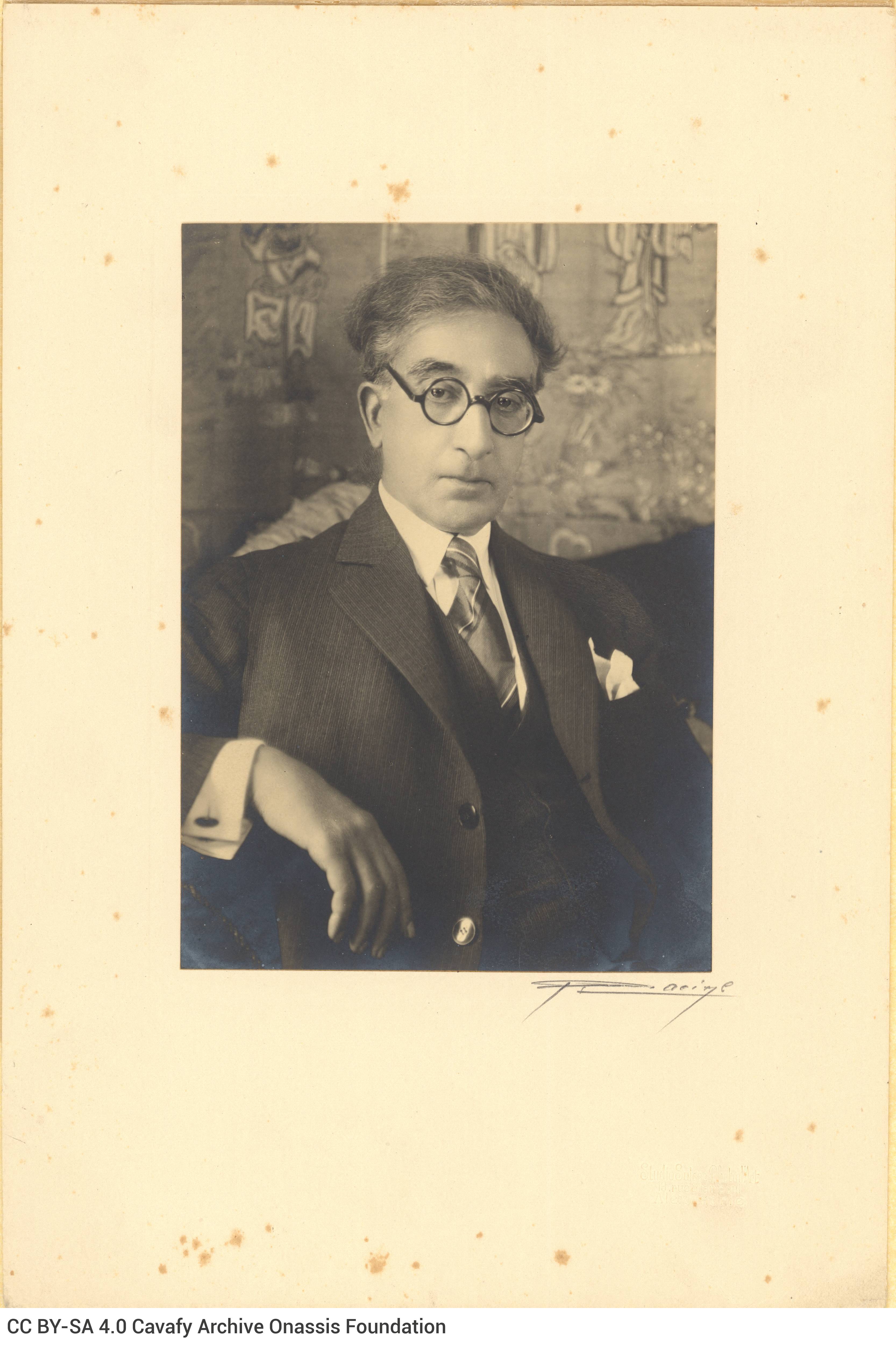 Photographic portrait of Cavafy at a mature age in his flat, pasted on paperboard and covered in rice paper with the logo of 