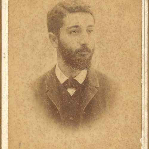 Photographic portrait of a young man with a moustache and a beard. The logo of the photographer in the lower part of the rect