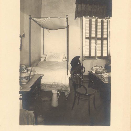 View of the interior of Cavafy's flat. It depicts the poet's bedroom, with his bed, chairs, a desk and other furniture. Three