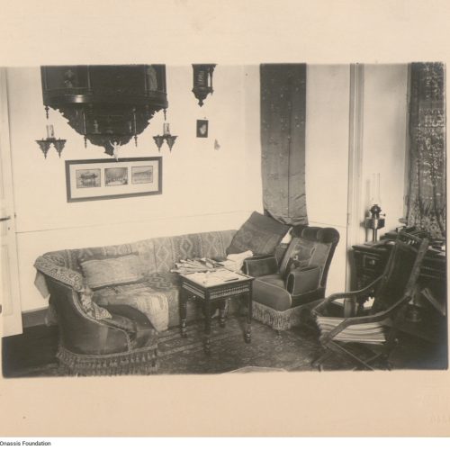 View of the interior of Cavafy's flat. It depicts the living room, with a sofa, armchairs and a desk. According to the handwr