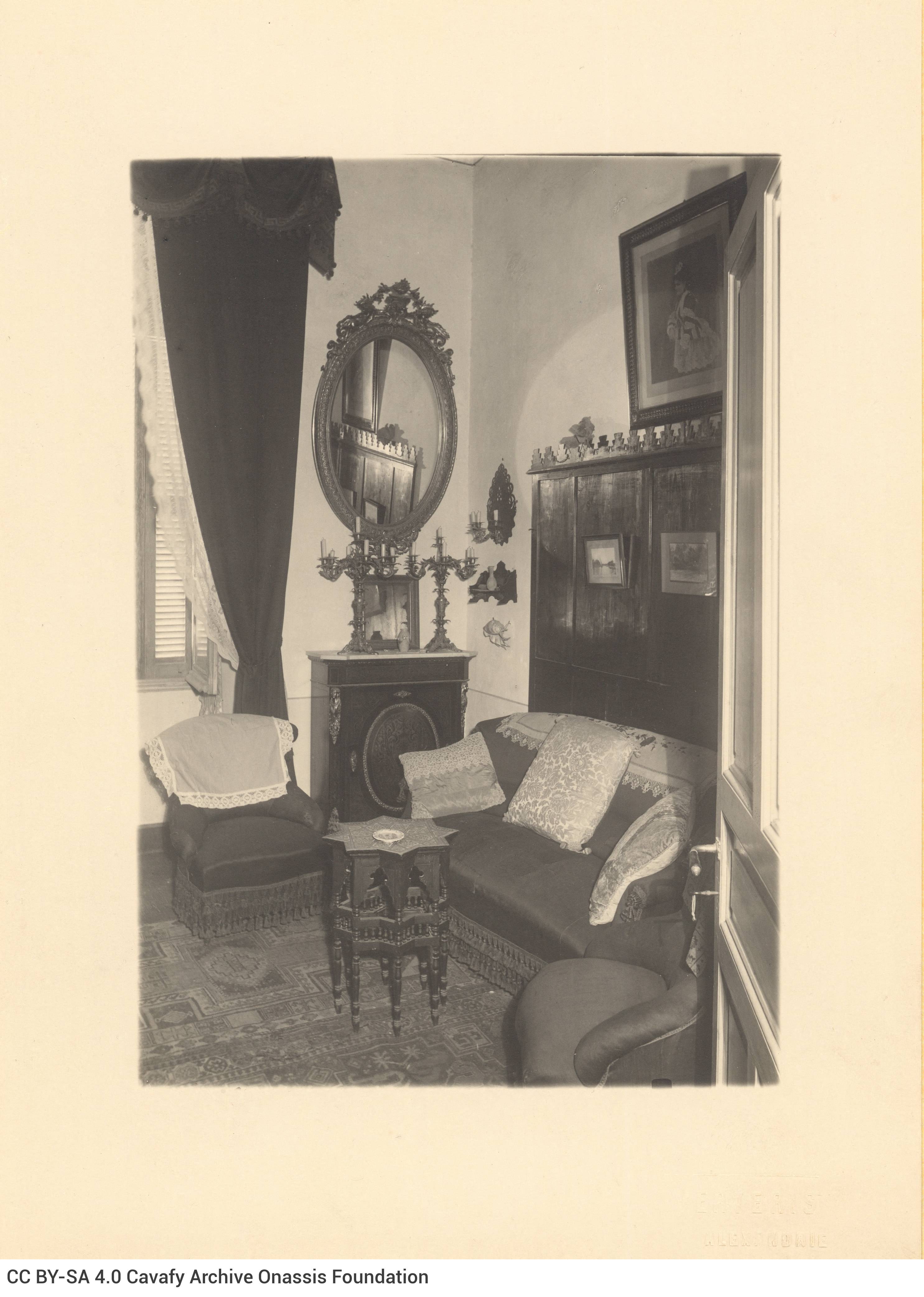 Photograph of the interior of Cavafy's flat. View of the living room, with a sofa, armchairs, a piece of furniture with candl